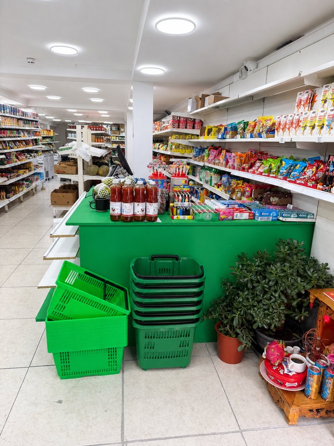 Green shop counter with sweets, chewing gum and confectionery display