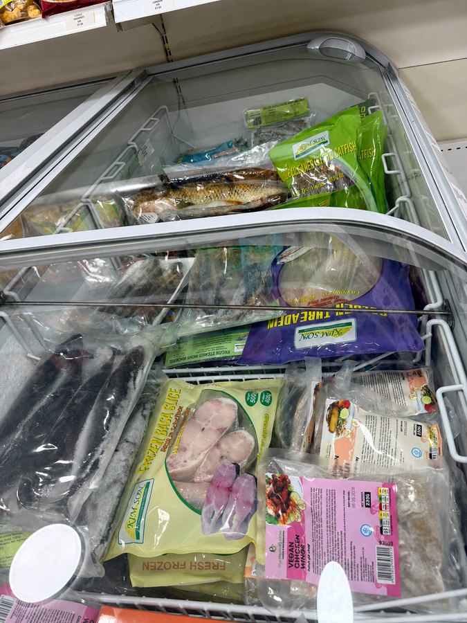 Freezer of whole catfish, basa fish slices and mackerel
