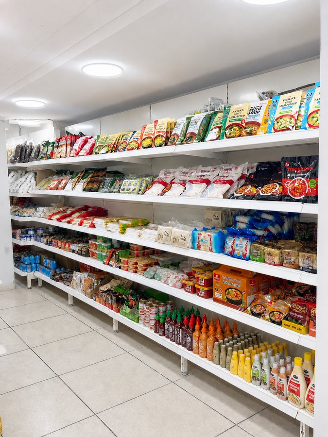 Shelves of miso soup, tteokbokki rice cakes, sriracha and Japanese mayo