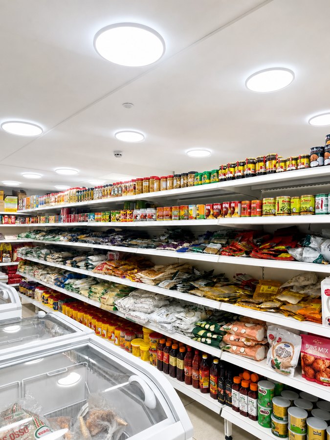 Aisle of palm oil, groundnut paste, stew bases and Milo tins