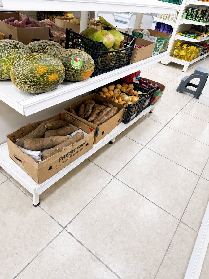Boxes of fresh yam from Ghana, cassava, coconut, melons and onions
